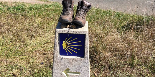 pair of boots placed atop a stone