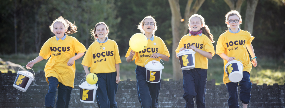 A group of school girls wearing Focus Ireland t-shirts on a school sponsored walk.