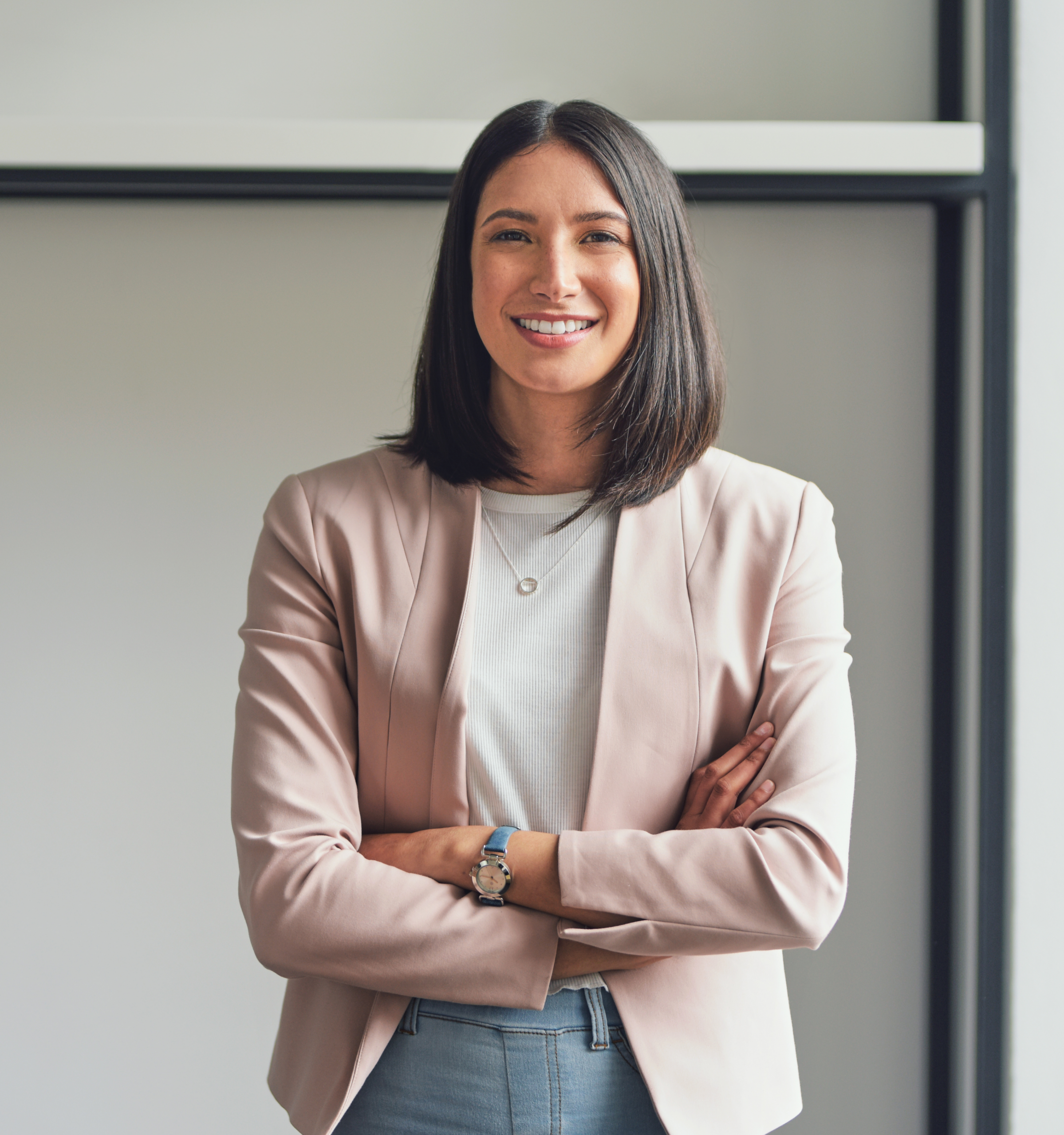 Focus Ireland staff member smiling towards the camera. She has her arms crossed.