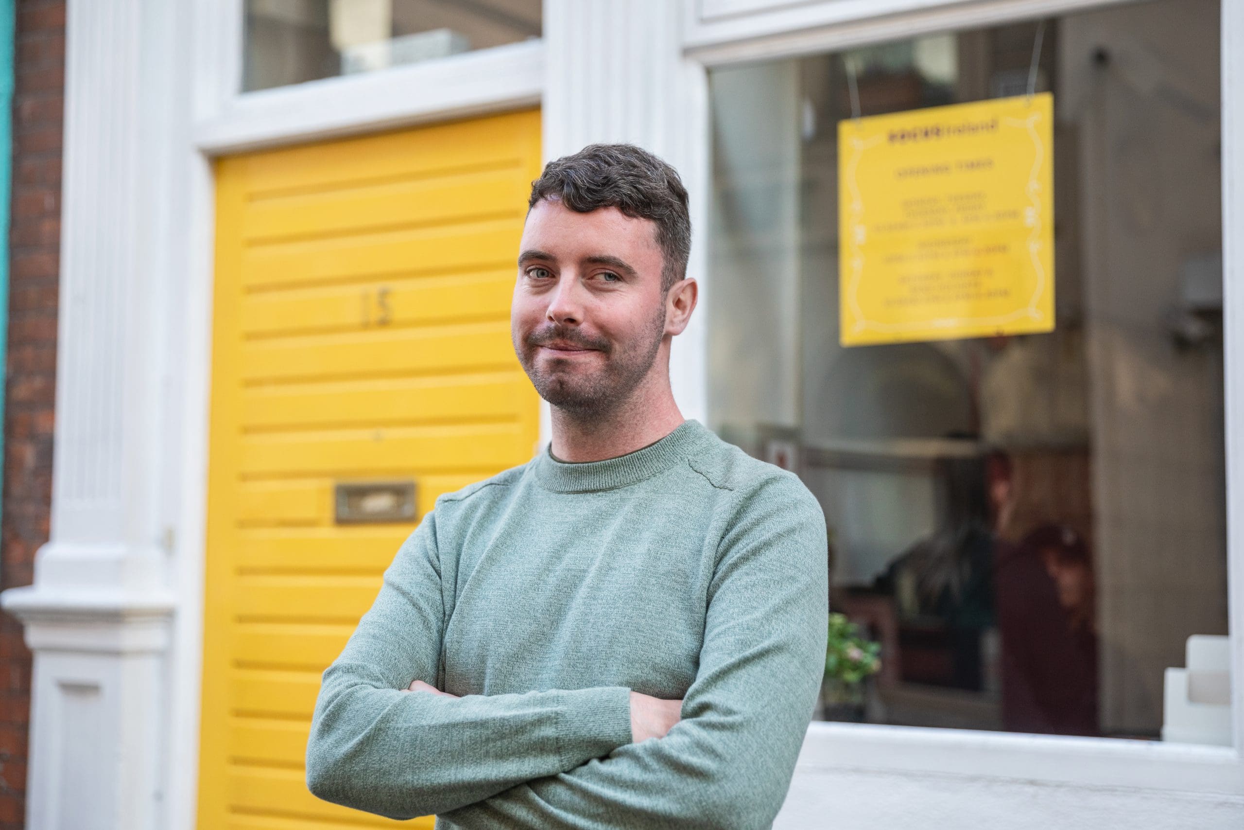 A portrait picture of a man standing outside the Focus Ireland Coffee Shop.