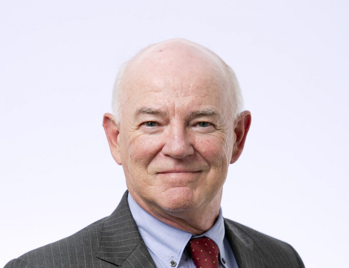 A portrait of David Kelly, a white middle aged white man with white short hair.