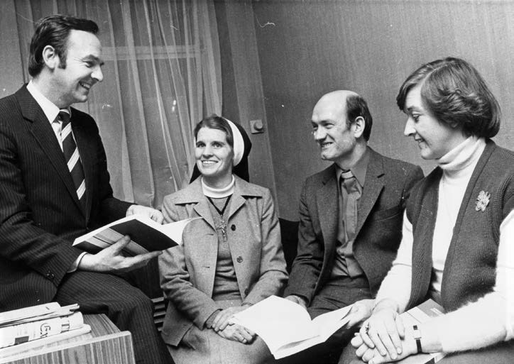 Four people sit and smile. Sister Stan is in the middle. The Photo is black and White and was taken in the 1970's