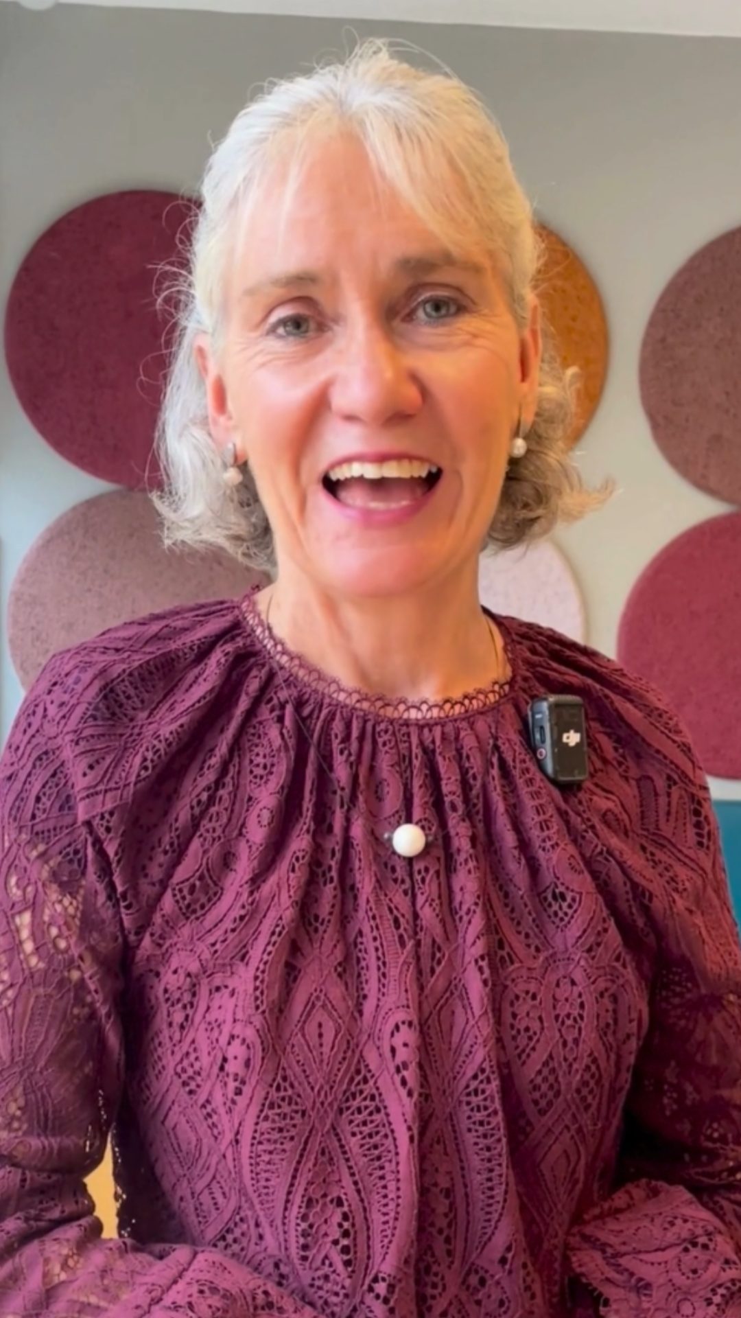 Susan Mullholland speaks to camera. They are wearing a purple top.