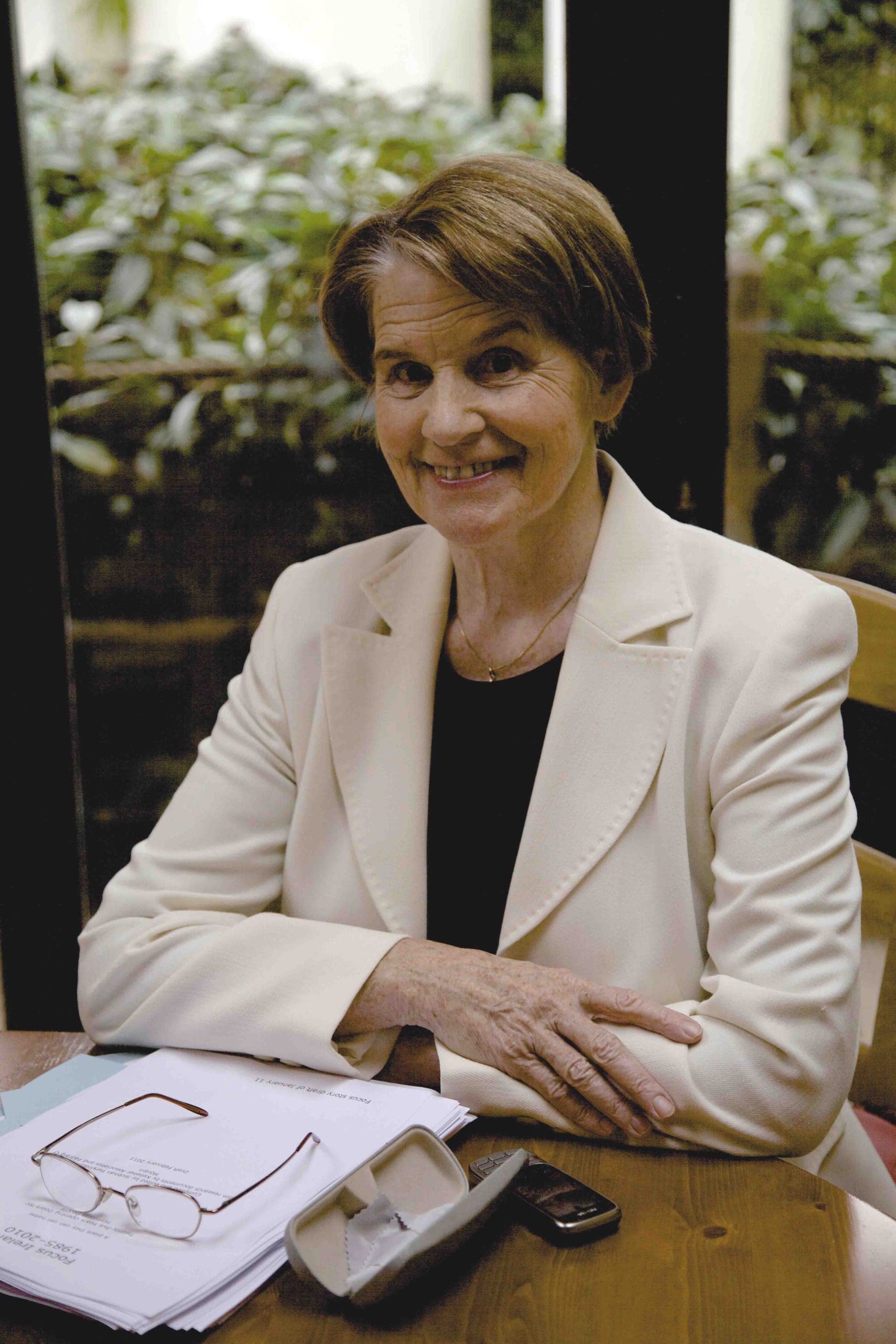 A picture of Sister Stan. They are sitting at a desk smiling to camera.